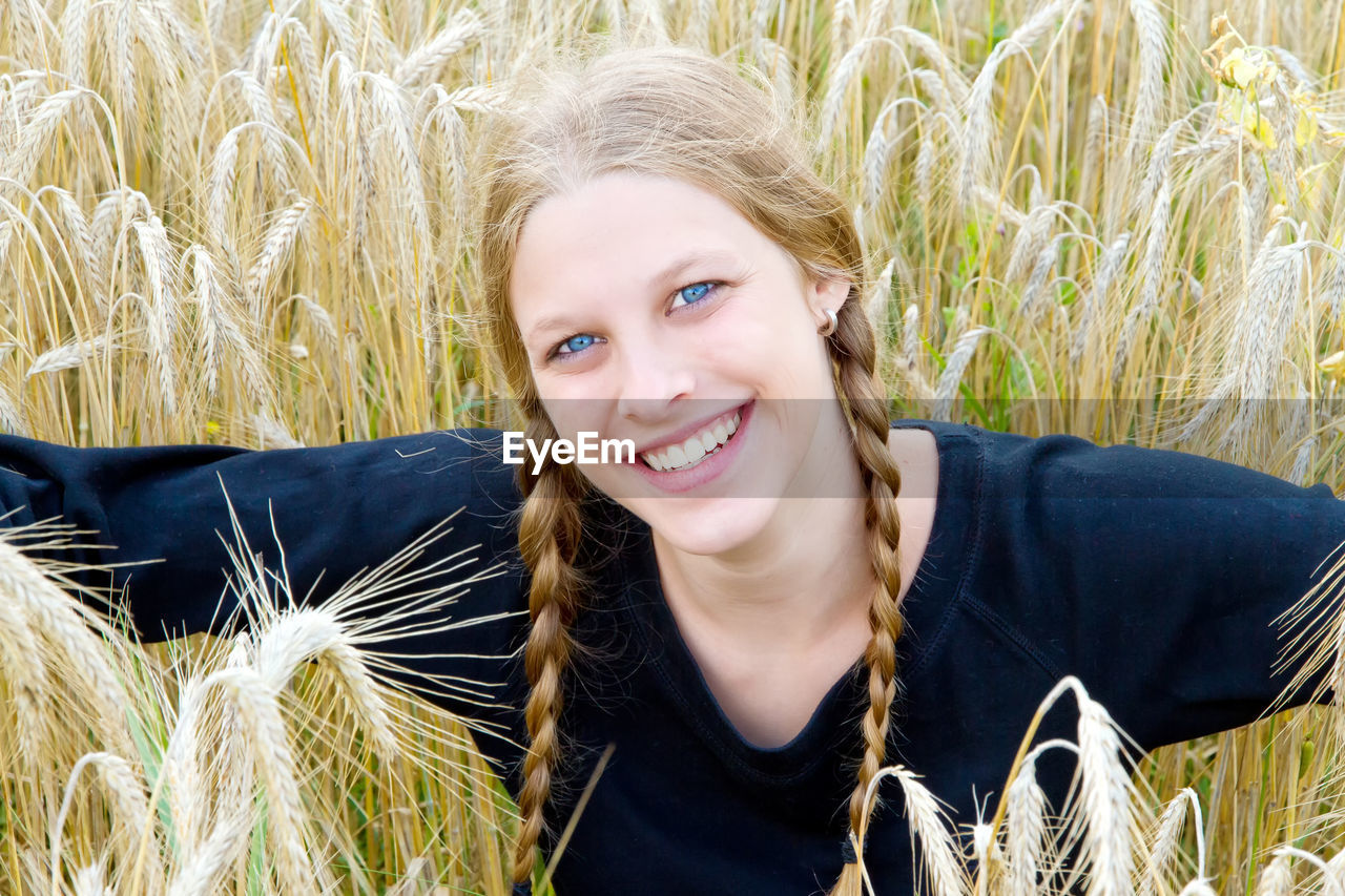 Portrait of smiling young woman in field