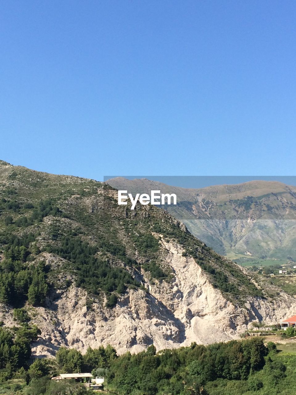 Scenic view of mountains against clear blue sky