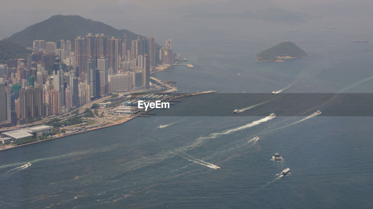 HIGH ANGLE VIEW OF SEA AND BUILDINGS IN BAY