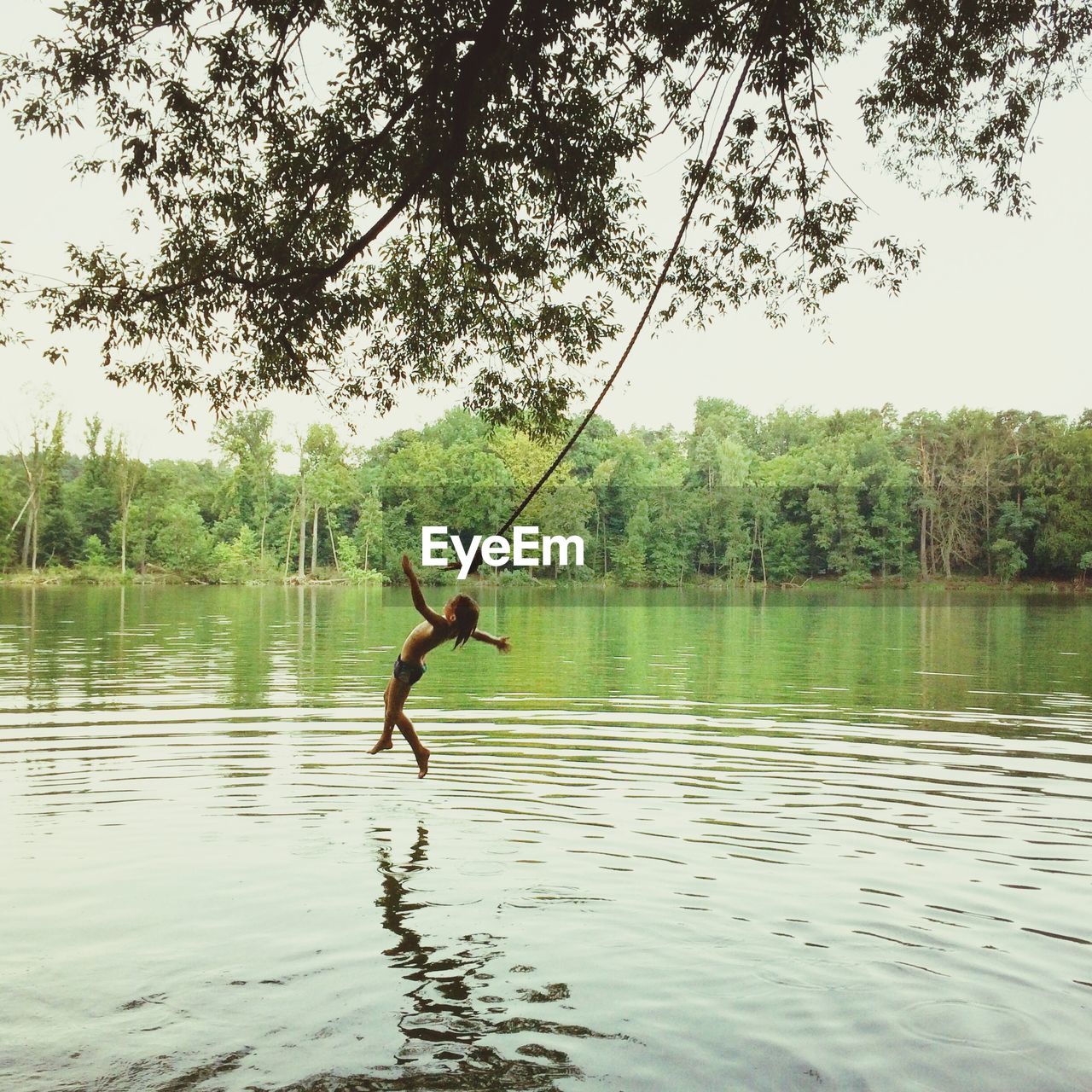 WOMAN JUMPING IN LAKE
