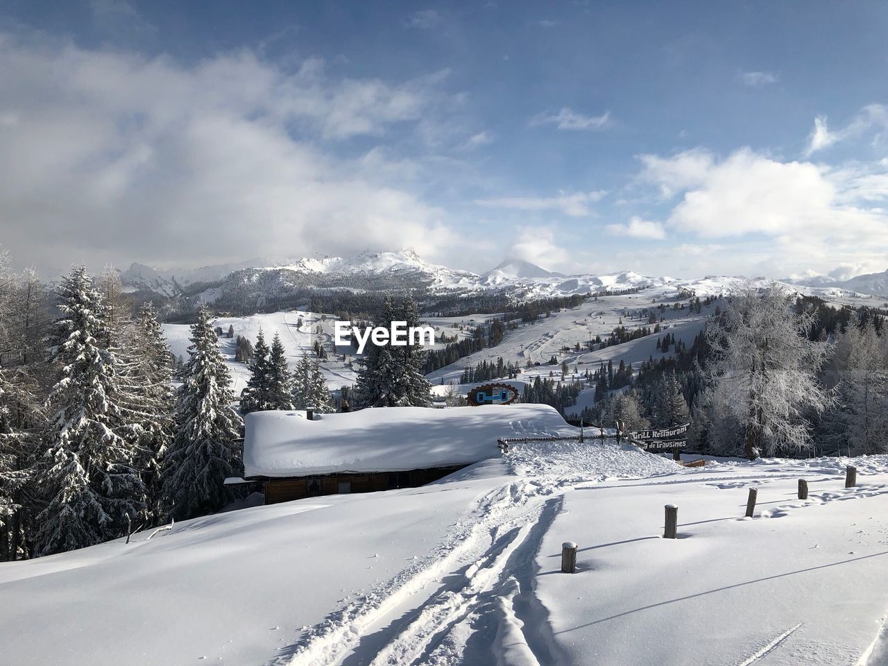 Snow covered landscape against sky