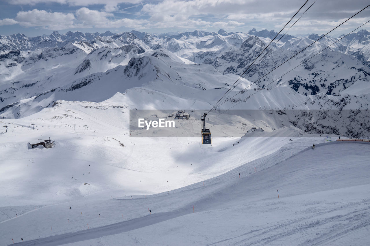 Cable car hanging over snowcapped mountain