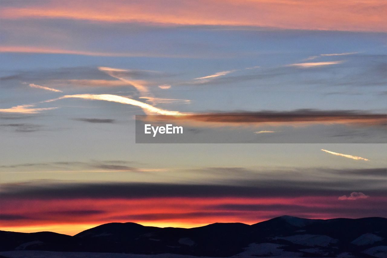 SCENIC VIEW OF DRAMATIC SKY OVER SILHOUETTE LANDSCAPE