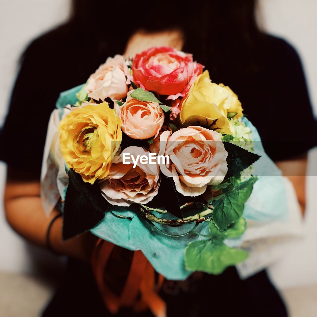 Midsection of woman holding bouquet