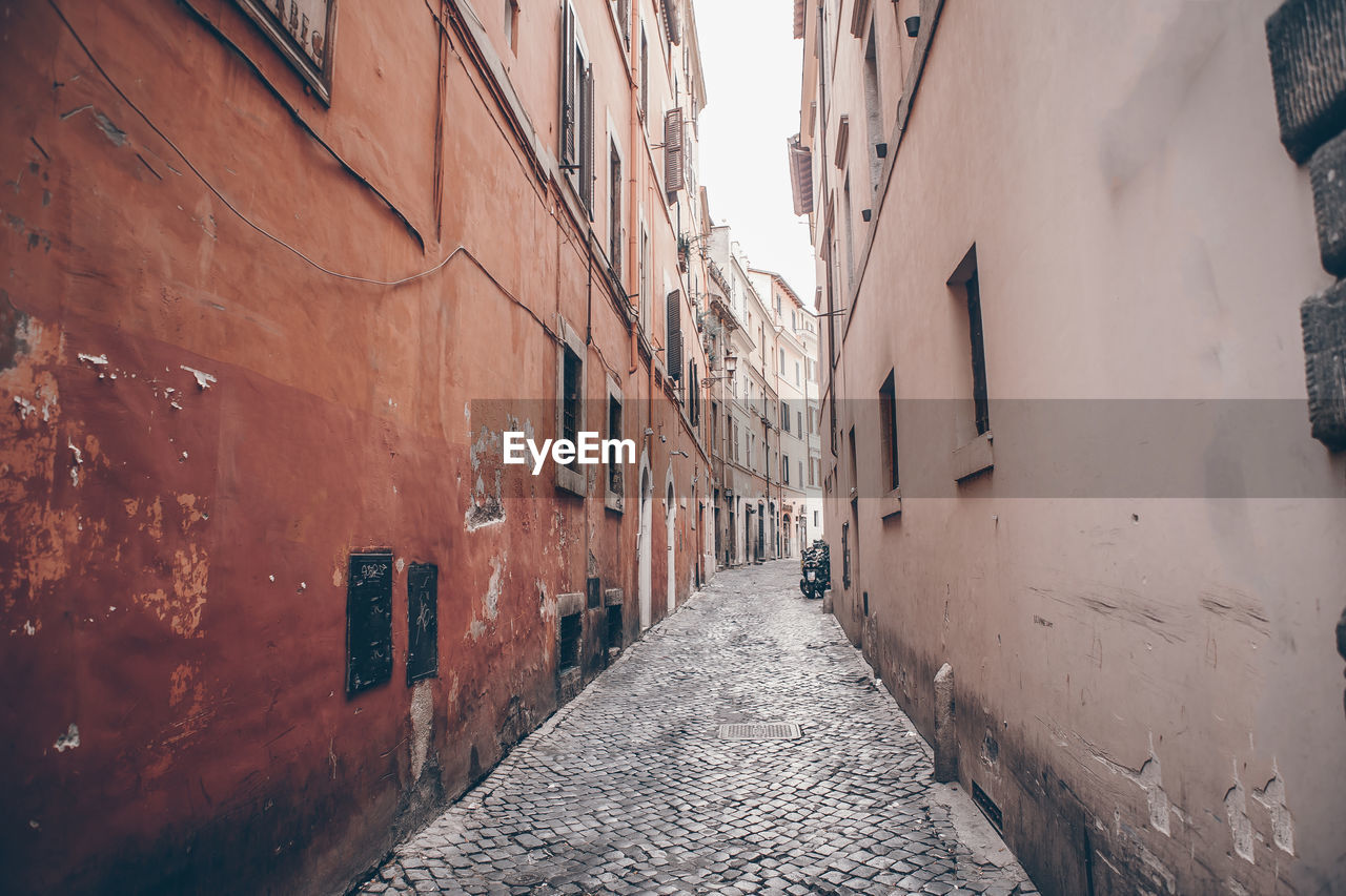 narrow street amidst buildings in city