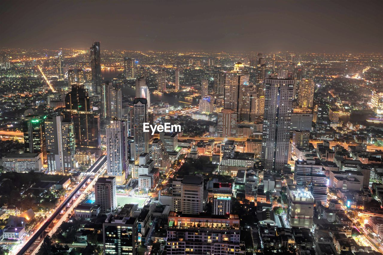 High angle view of illuminated buildings in city at night