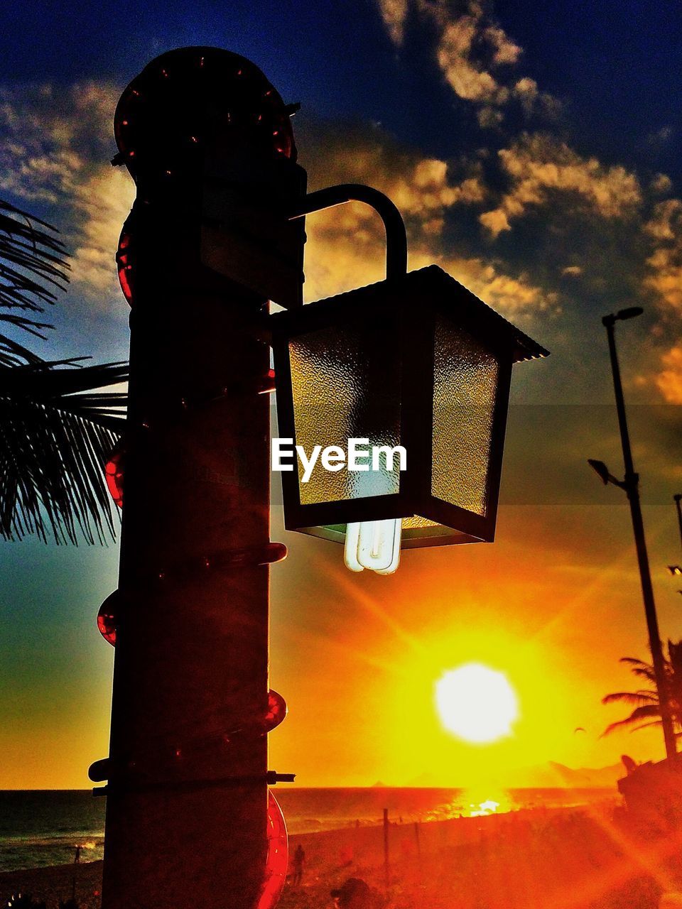 Low angle view of street light at sunset