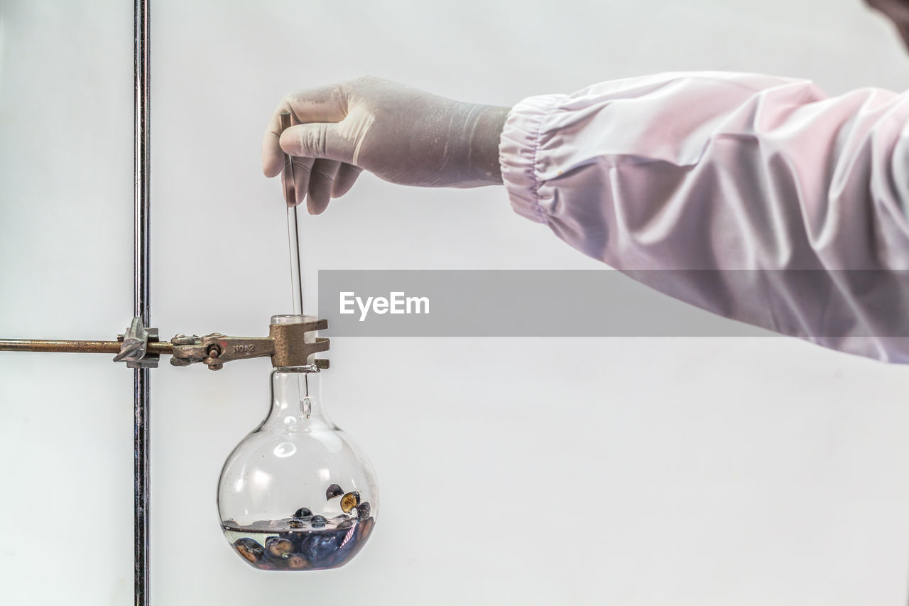 Cropped hand of scientist analyzing chemical in laboratory