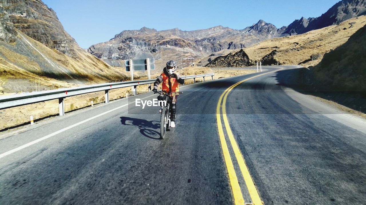 Man riding bicycle on road