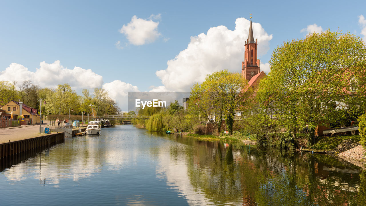 Panoramic view of trees and city against sky