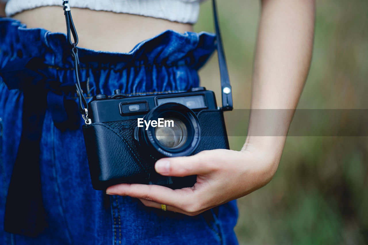 Midsection of woman photographing