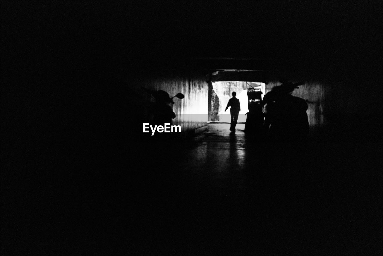 WOMAN WALKING IN TUNNEL