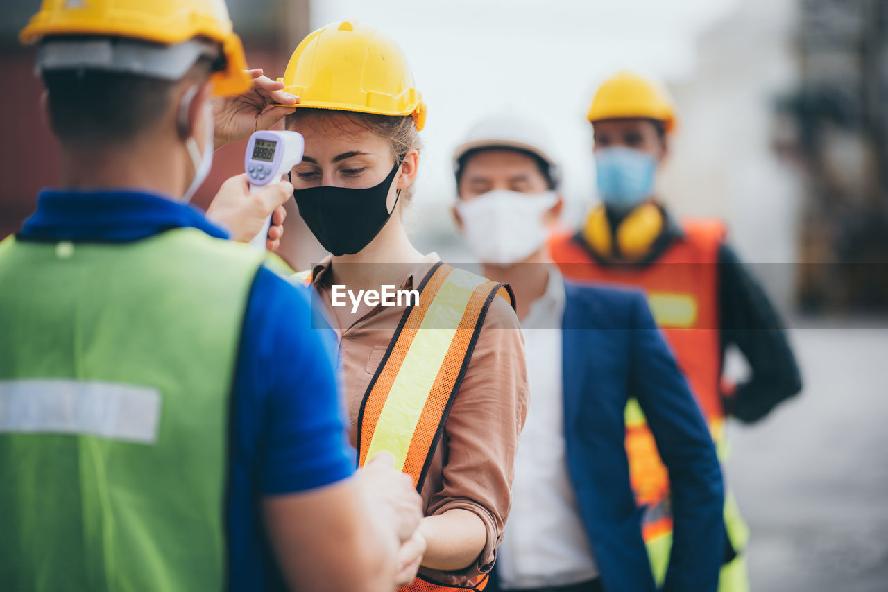 PEOPLE WORKING IN CONSTRUCTION SITE