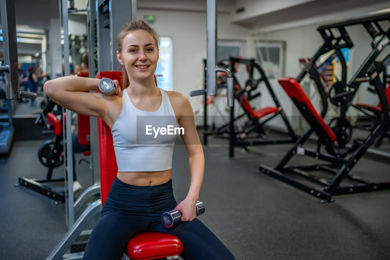 side view of woman exercising in gym