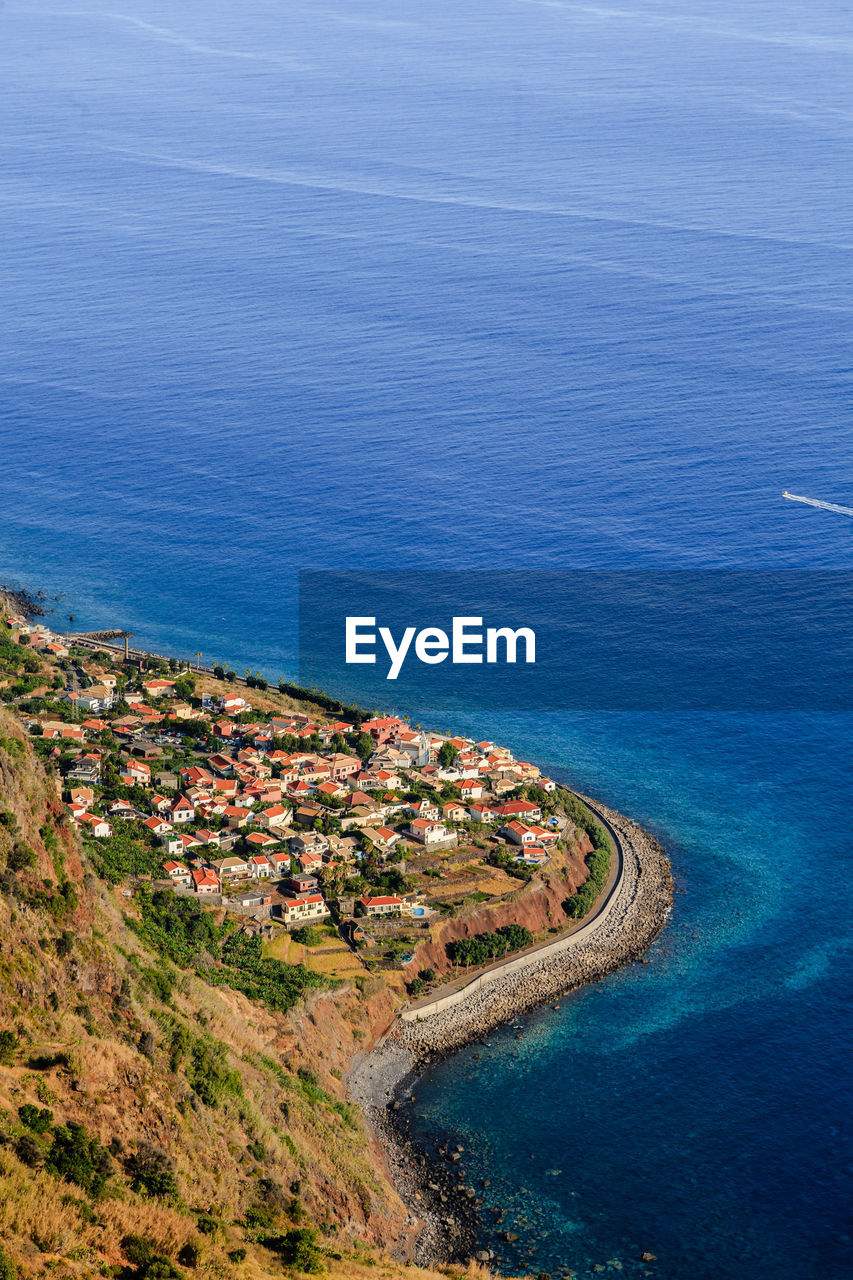 High angle view of sea and buildings in vilage