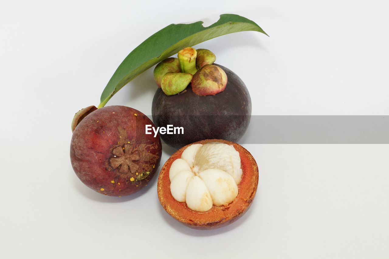 food and drink, food, healthy eating, fruit, wellbeing, freshness, plant, studio shot, produce, common fig, no people, indoors, still life, plant part, cut out, leaf, tropical fruit, white background, nut - food, nut, fig, group of objects