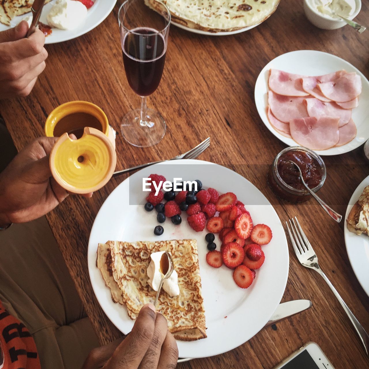 Cropped image of people having breakfast at table