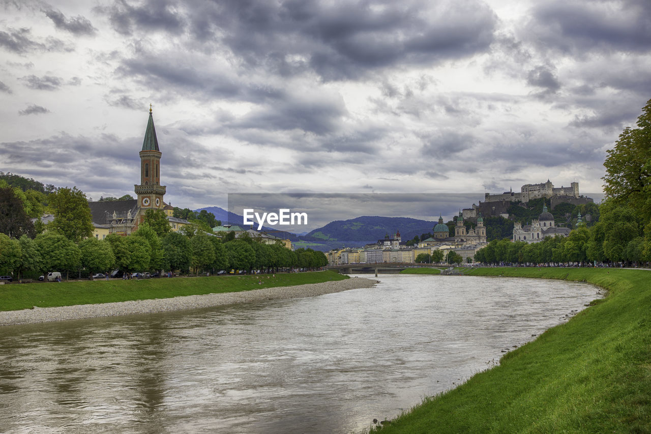 RIVER PASSING THROUGH BUILDINGS AGAINST SKY