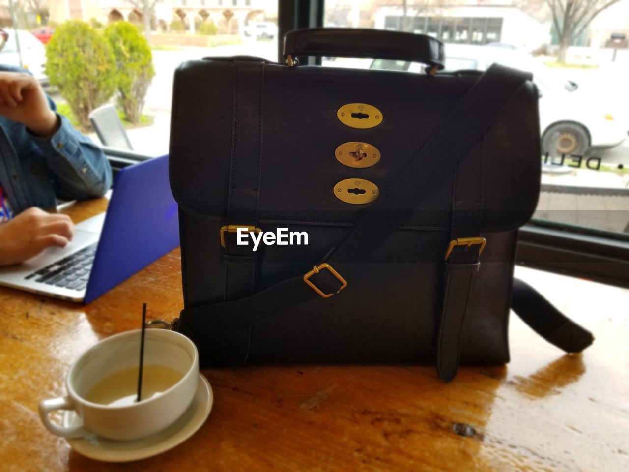 CLOSE-UP OF SMART PHONE ON TABLE IN KITCHEN