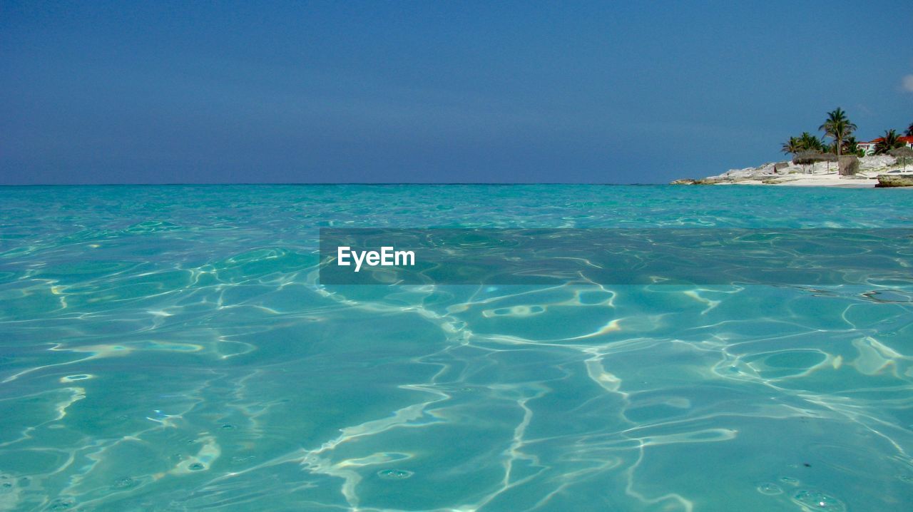 Scenic view of sea against blue sky