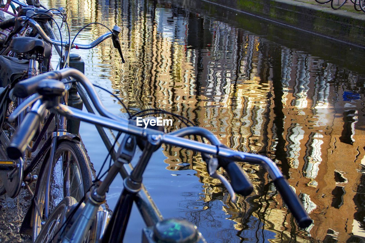 CLOSE-UP OF BICYCLE BY WATER