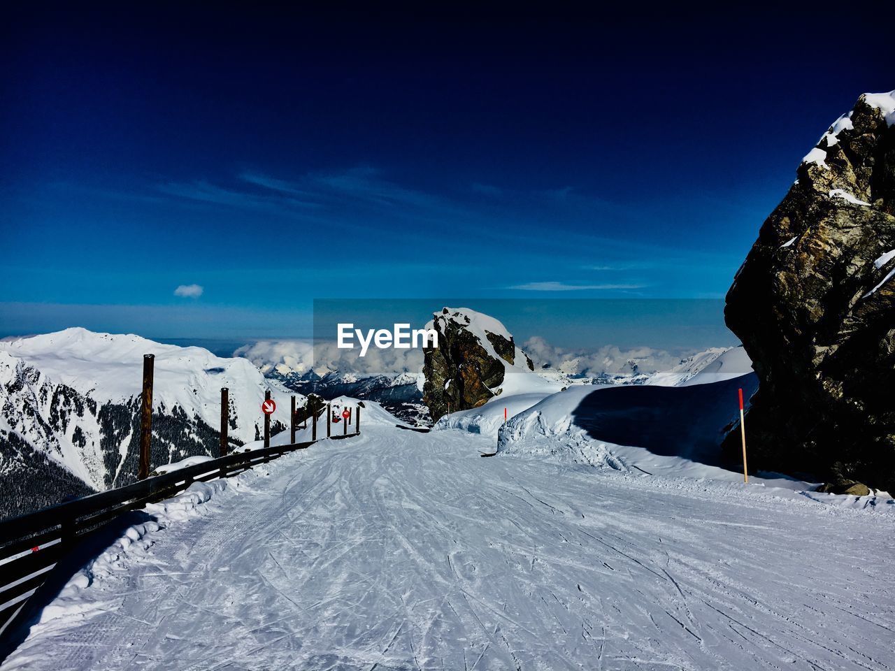 SNOW COVERED MOUNTAIN AGAINST BLUE SKY