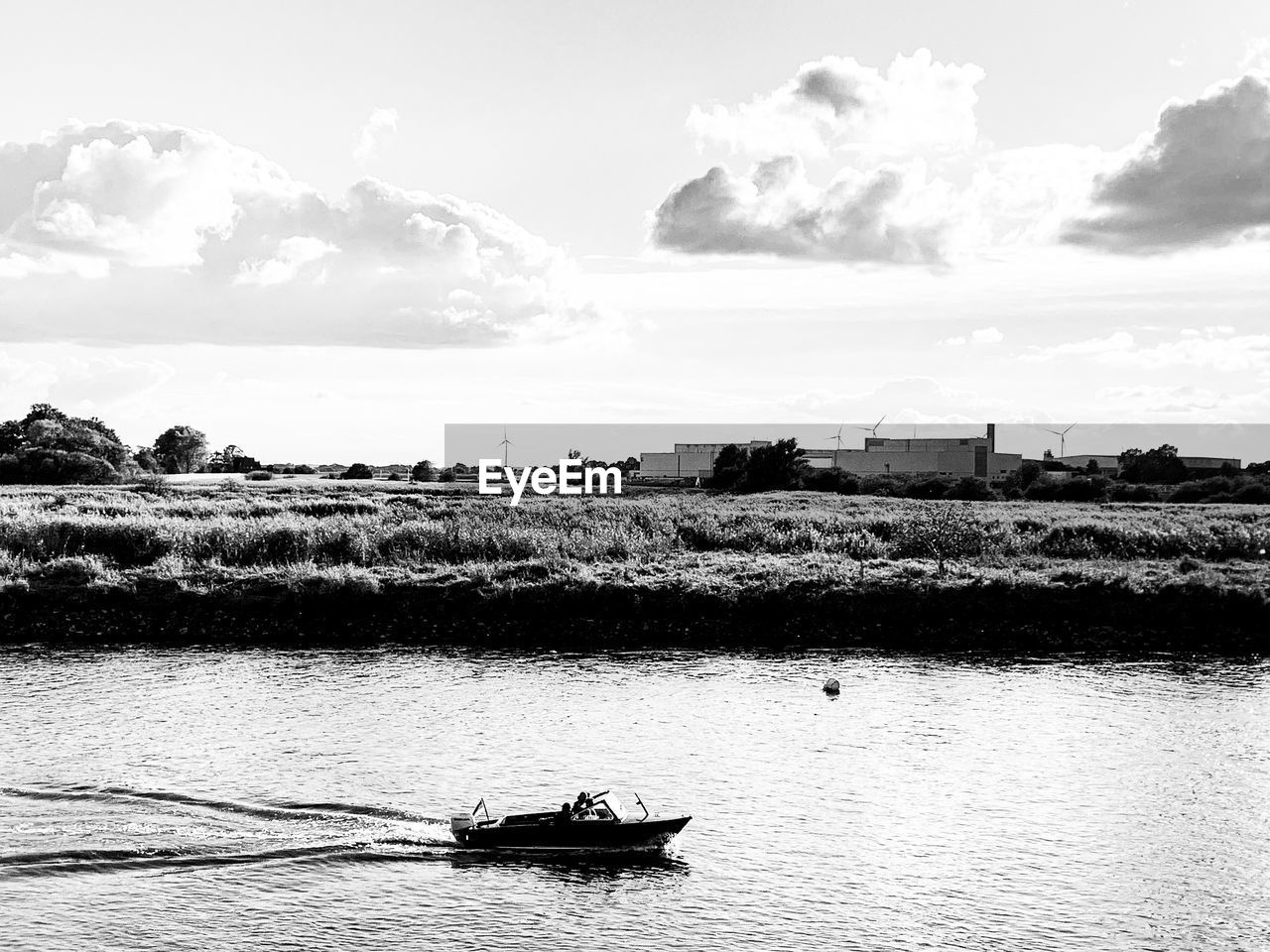 NAUTICAL VESSEL SAILING ON RIVER AGAINST SKY