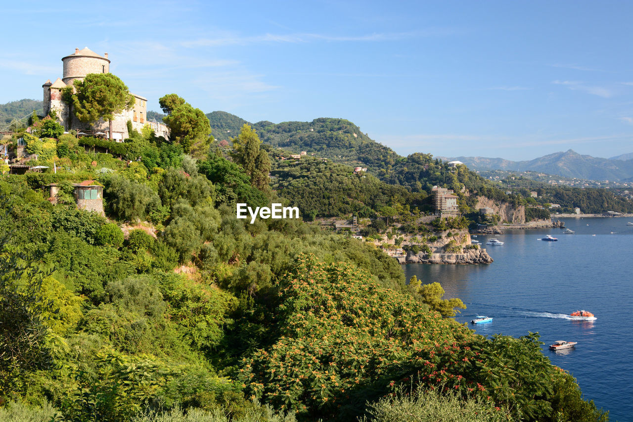 water, architecture, sea, building exterior, nature, built structure, sky, plant, coast, tree, travel destinations, land, building, travel, mountain, scenics - nature, nautical vessel, beauty in nature, tourism, transportation, vacation, no people, city, day, beach, outdoors, environment, blue, landscape, coastline, cliff, history, high angle view, mode of transportation, the past, tranquility, holiday, aerial photography, house, terrain, town, residential district, trip, sunlight, clear sky, harbor, tranquil scene, sunny, flower, green