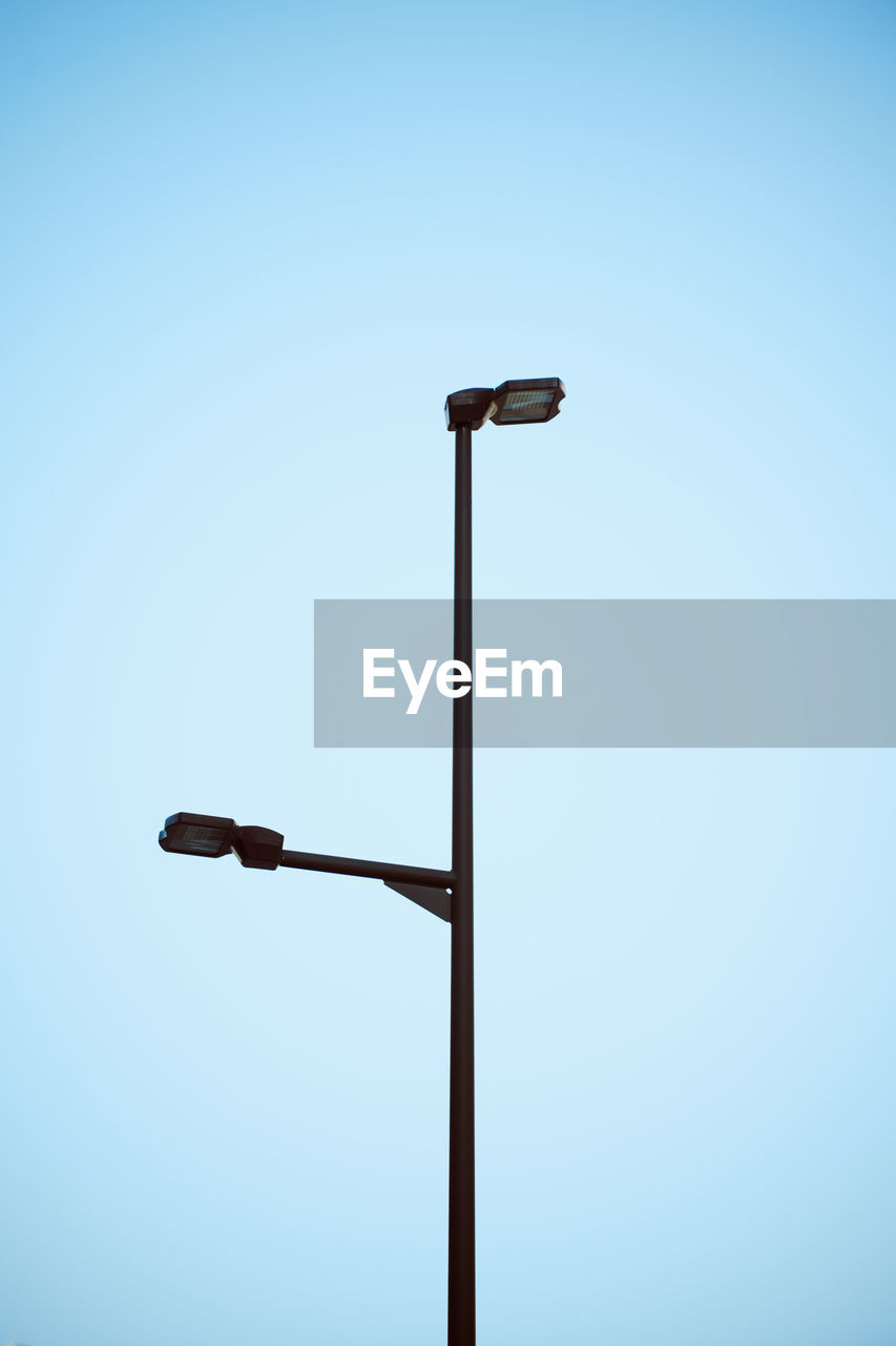 Low angle view of street light against clear blue sky