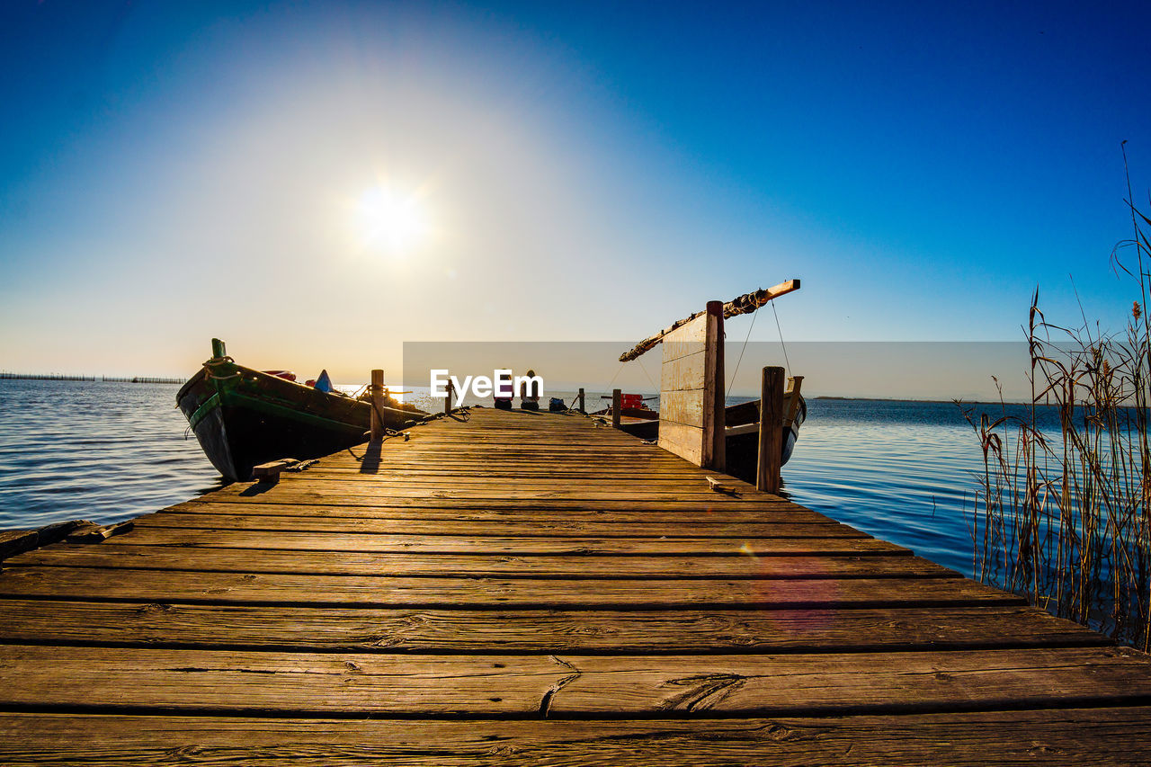 PIER AMIDST SEA AGAINST SKY