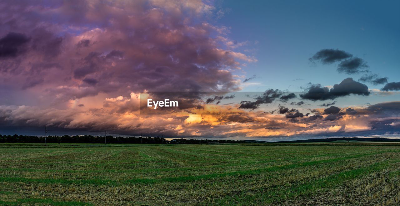 Scenic view of field against sky during sunset