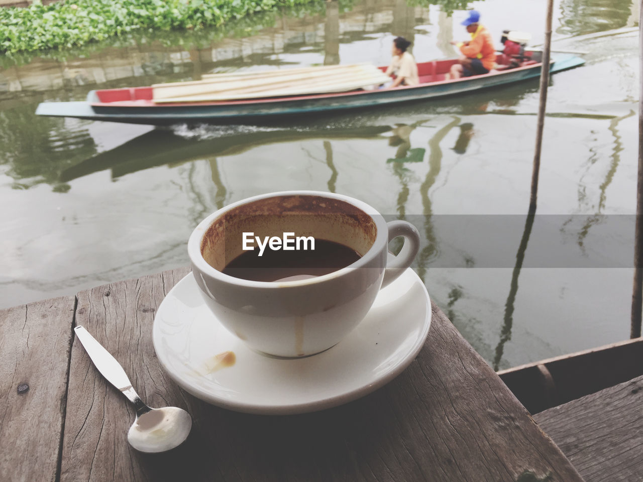 CLOSE-UP OF COFFEE CUP AND TABLE