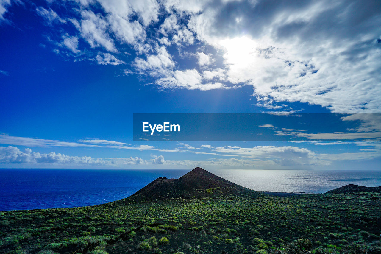 SCENIC VIEW OF SEA AND MOUNTAIN AGAINST SKY