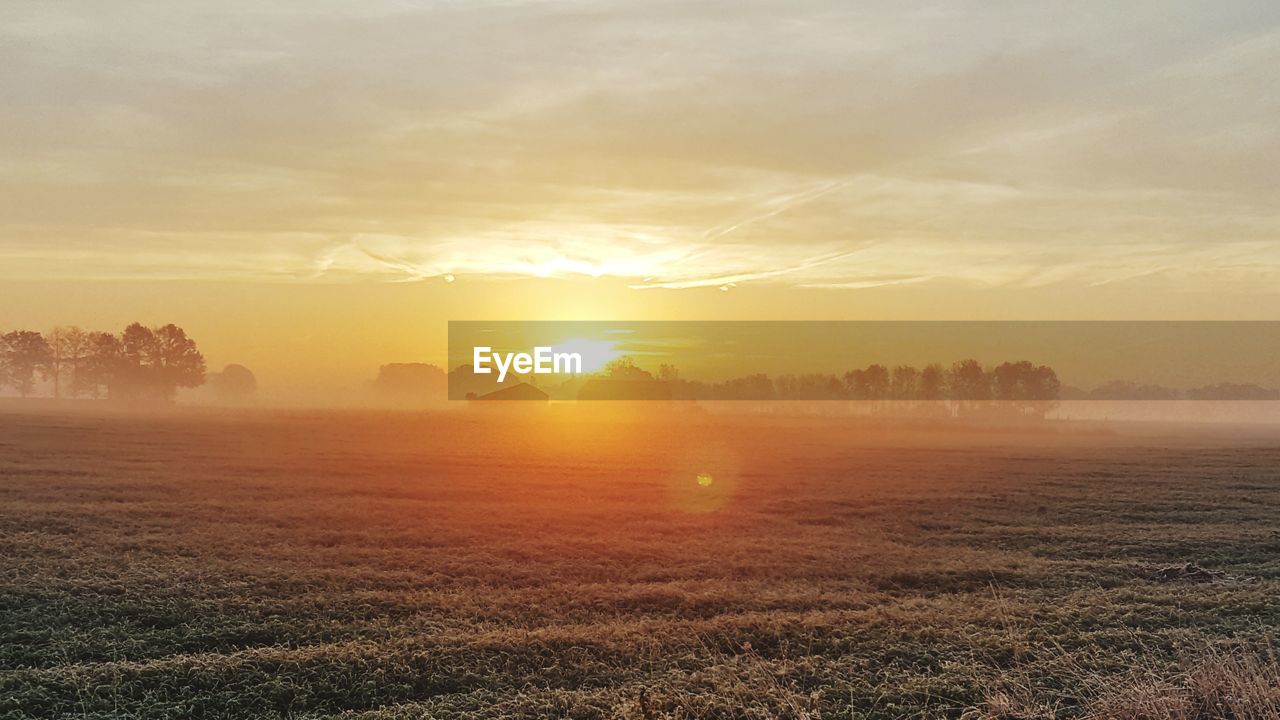 SCENIC VIEW OF SUNSET OVER LAND