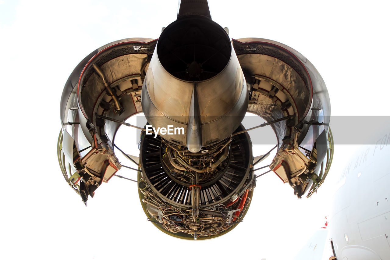 Low angle view of aircraft engine against sky