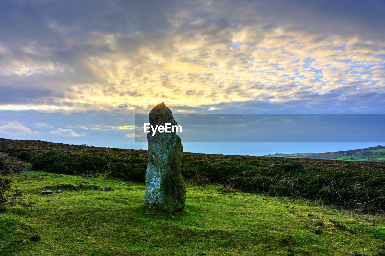 STONE WALL ON FIELD DURING SUNSET
