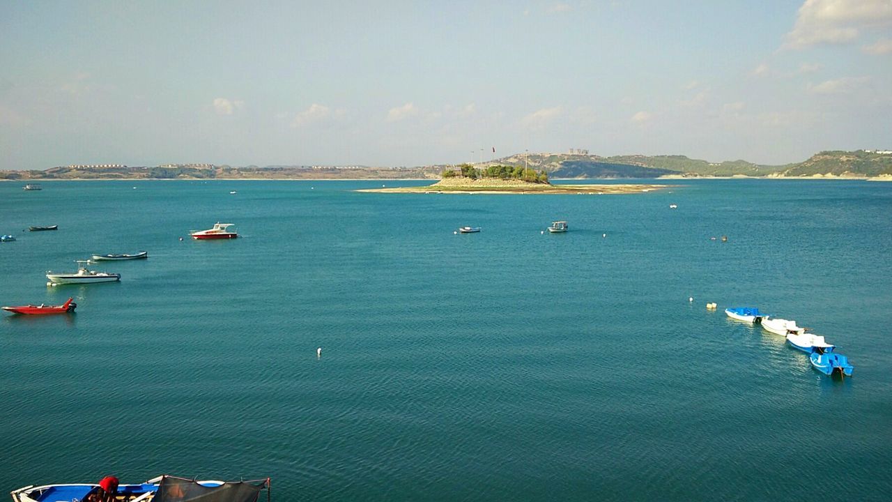 BOATS SAILING IN SEA AGAINST SKY