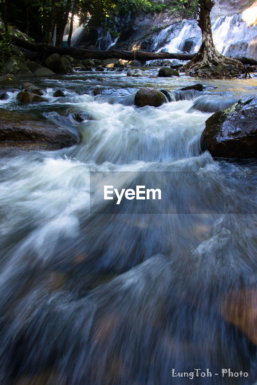 CLOSE-UP OF WATER FLOWING IN SUNLIGHT