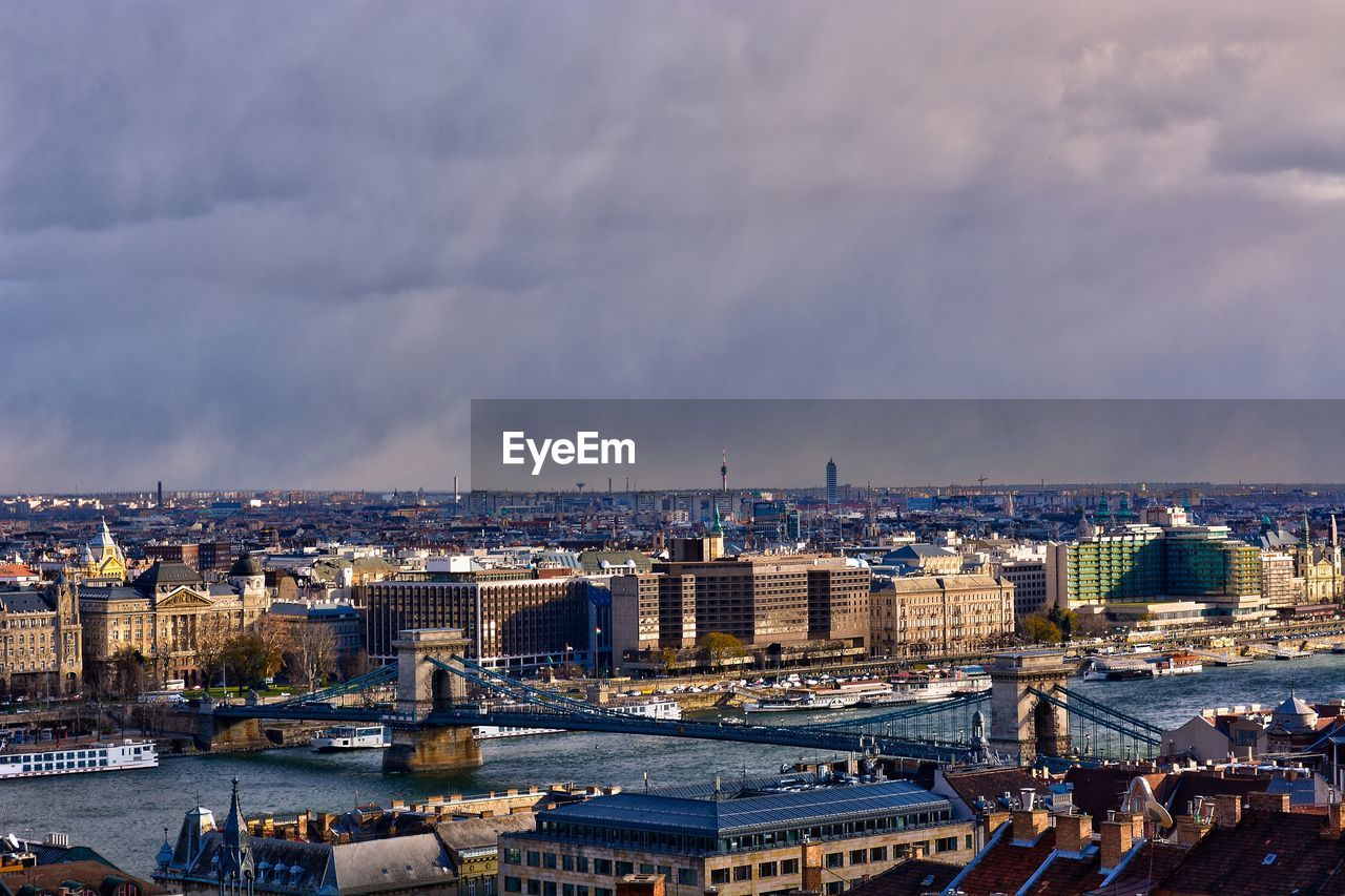 Chain bridge view from fishermans bastion high angle view of city buildings against cloudy sky