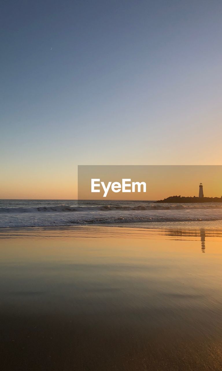 SCENIC VIEW OF BEACH AGAINST SKY DURING SUNSET