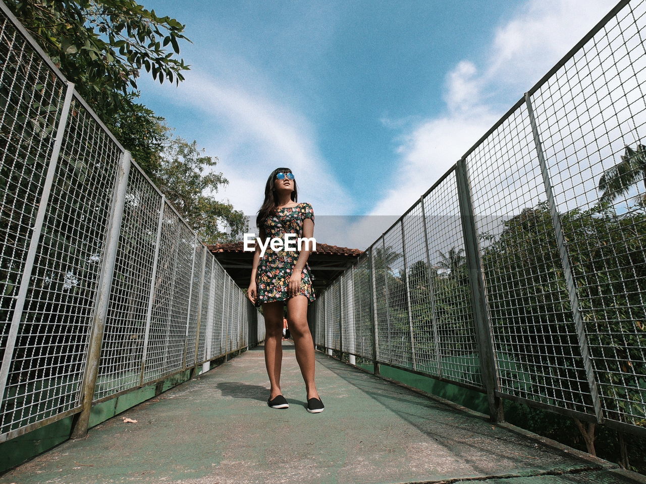 Low angle view of woman standing against sky