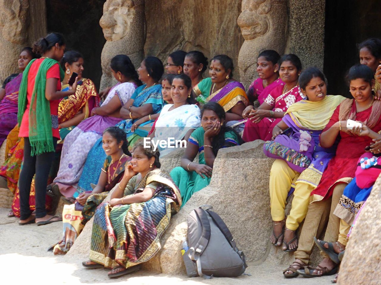 GROUP OF PEOPLE SITTING ON DISPLAY