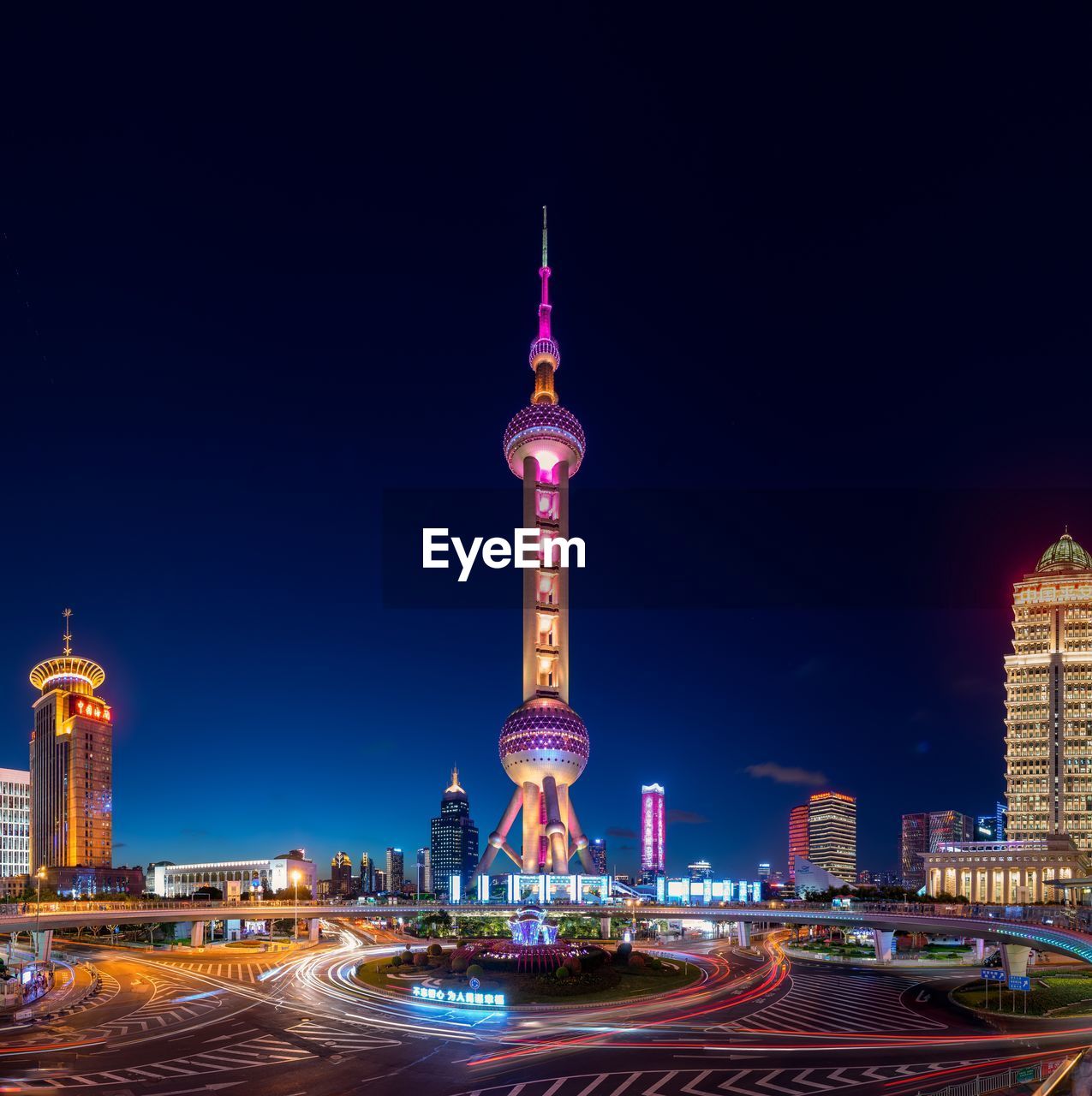 ILLUMINATED TOWER OF BUILDINGS AT NIGHT