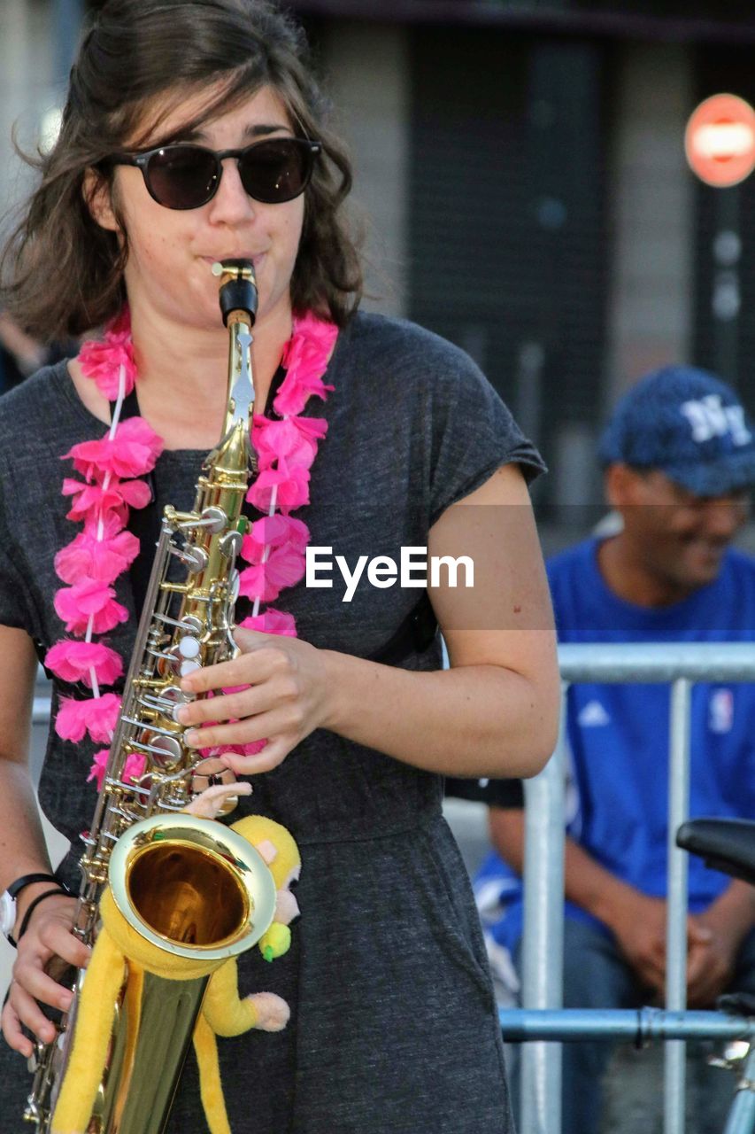 Mid adult woman wearing sunglasses at music concert