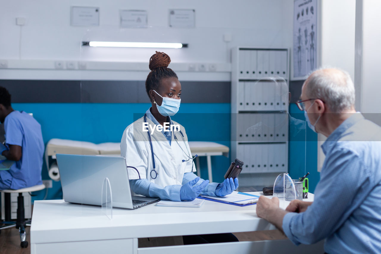 Doctor working at desk in office