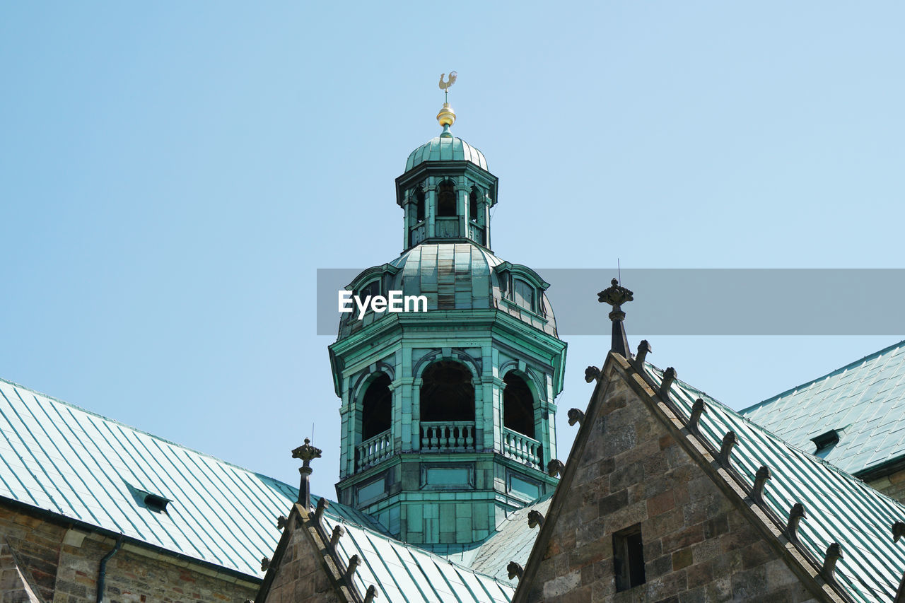 Low angle view of building against clear blue sky