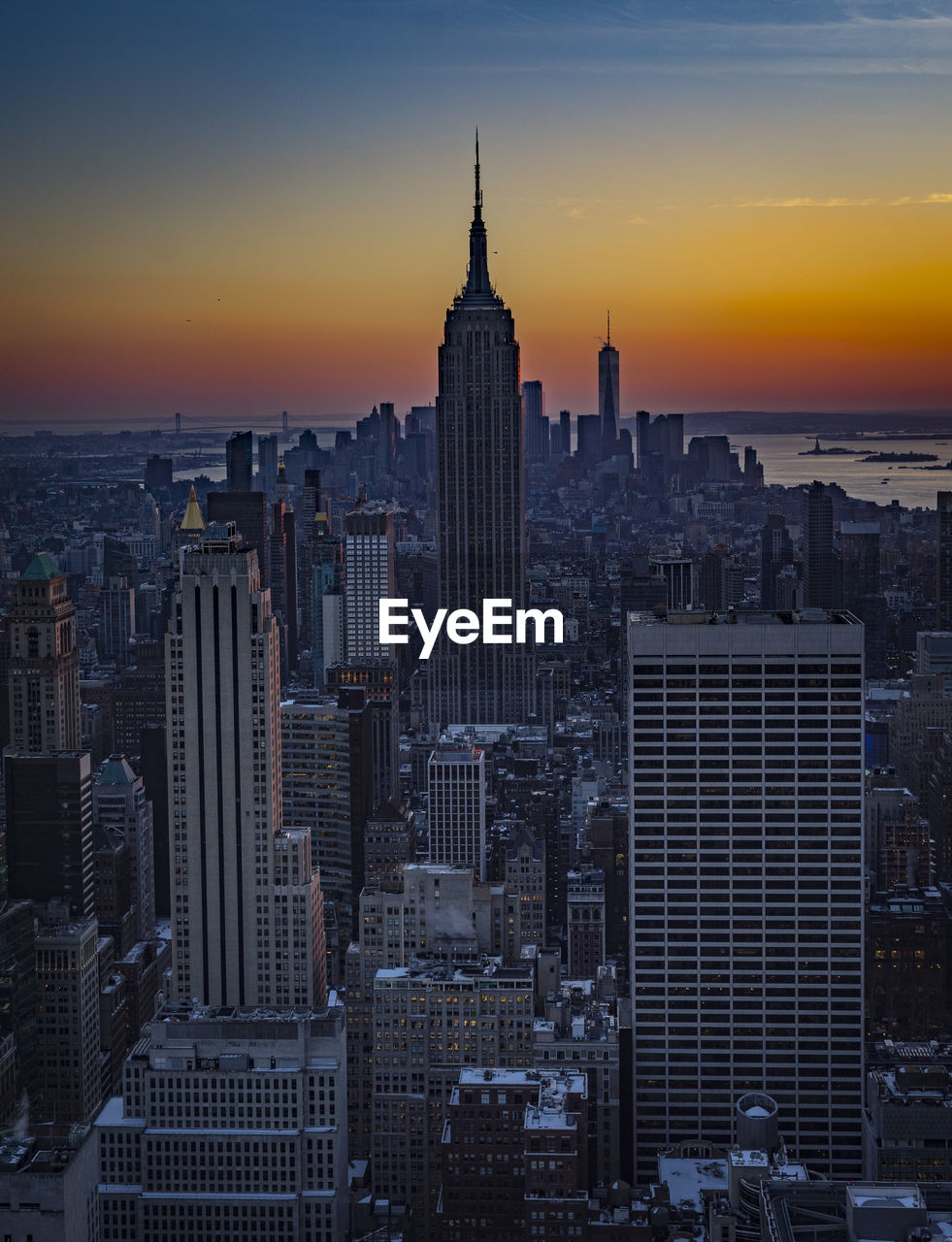 Aerial view of buildings in city during sunset