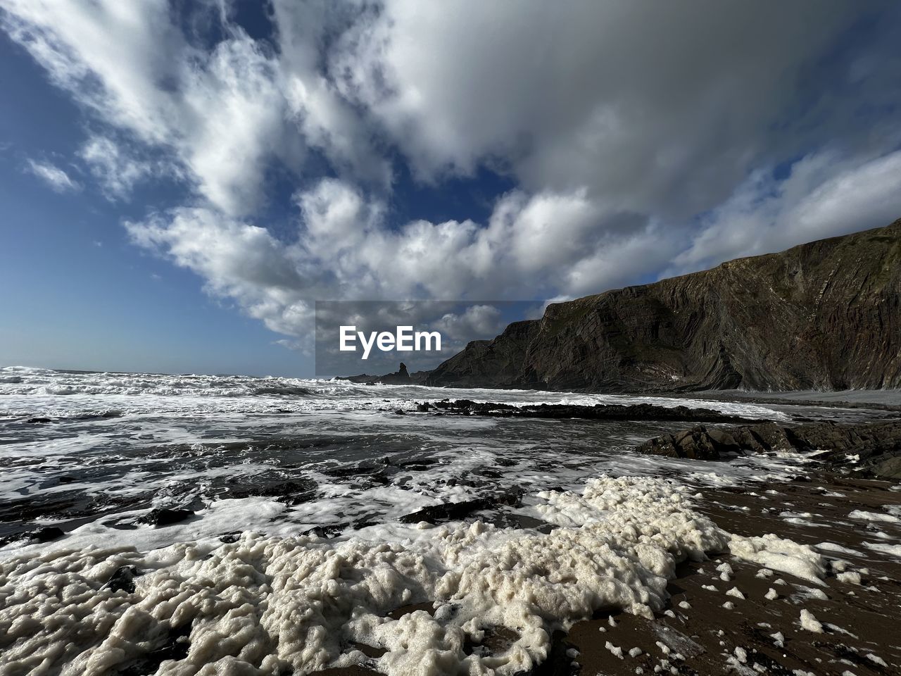 sky, cloud, sea, environment, nature, coast, scenics - nature, rock, landscape, wave, water, ocean, beauty in nature, shore, land, mountain, snow, cold temperature, horizon, travel, no people, winter, travel destinations, ice, outdoors, dramatic sky, beach, sunlight, non-urban scene, tranquility, day, tourism, cloudscape, dramatic landscape, wind wave
