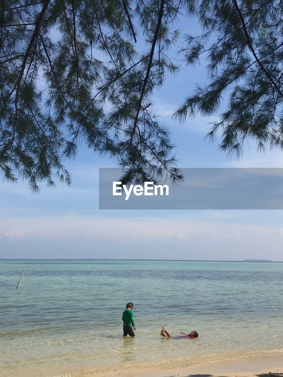 PEOPLE AT BEACH AGAINST SKY