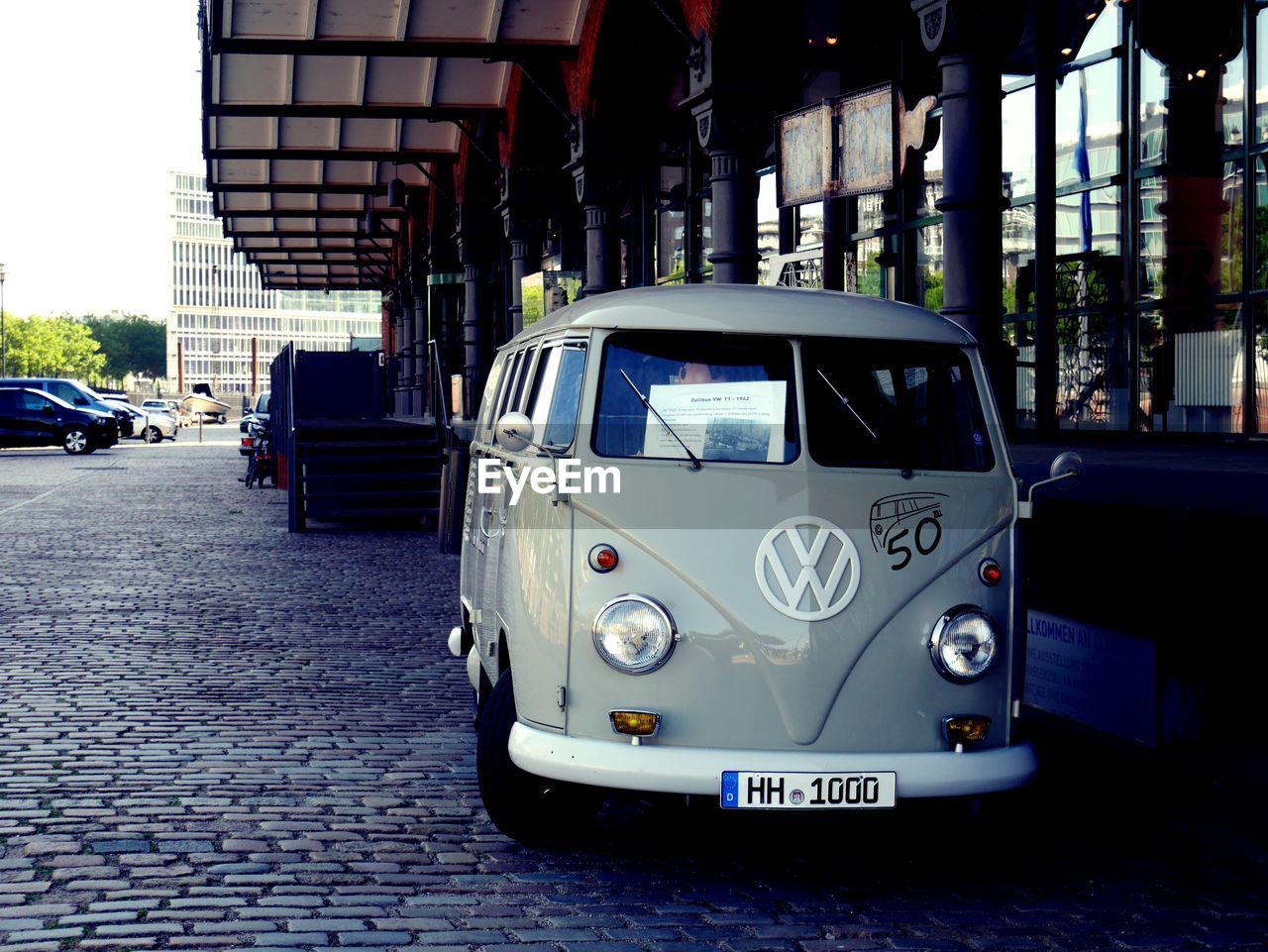 CAR ON STREET AGAINST BUILDING